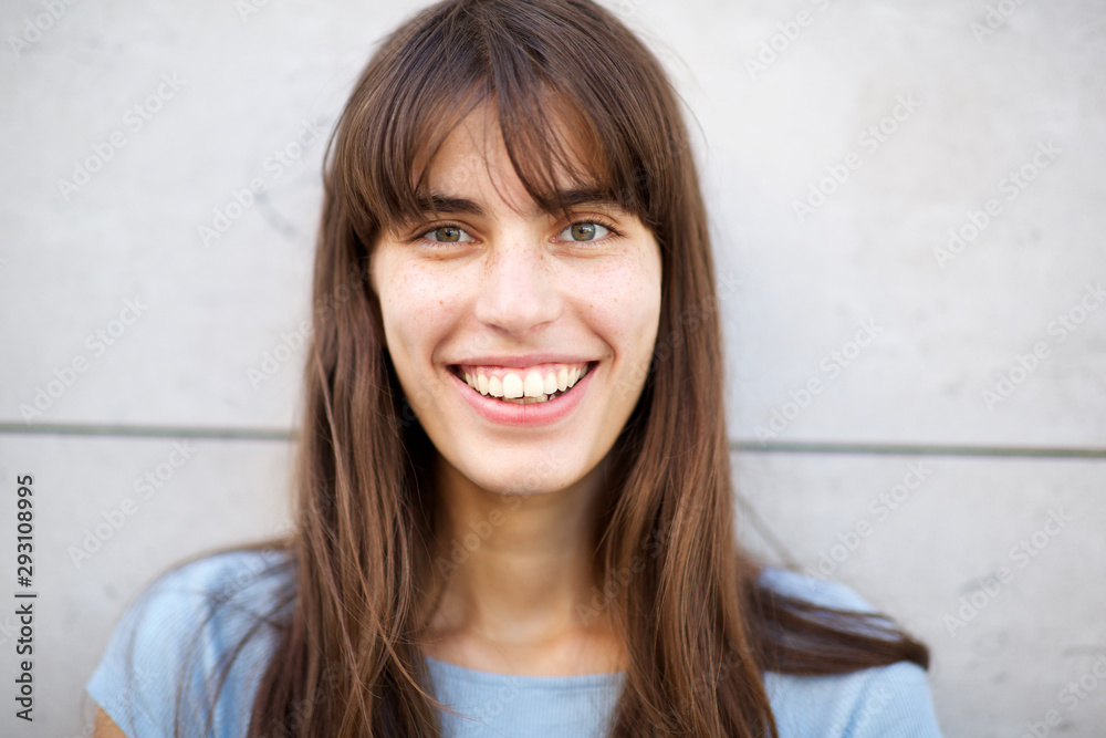 front portrait of young woman with big smile and long hair front portrait of young woman with big smile and long hair