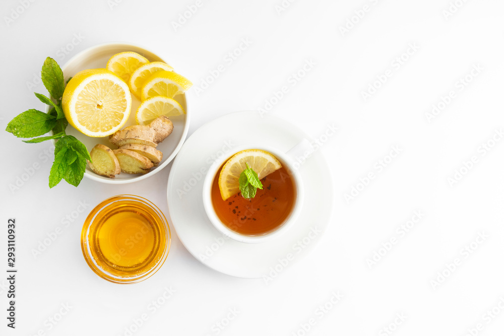 Fresh tea with lemon and honey on a white background. Hot tea cup isolated, top view flat lay. Flat lay. Autumn, fall or winter drink. Copy space. Fresh tea with lemon and honey on a white background. Hot tea cup isolated, top view flat lay. Flat lay. Autumn, fall or winter drink. Copy space.