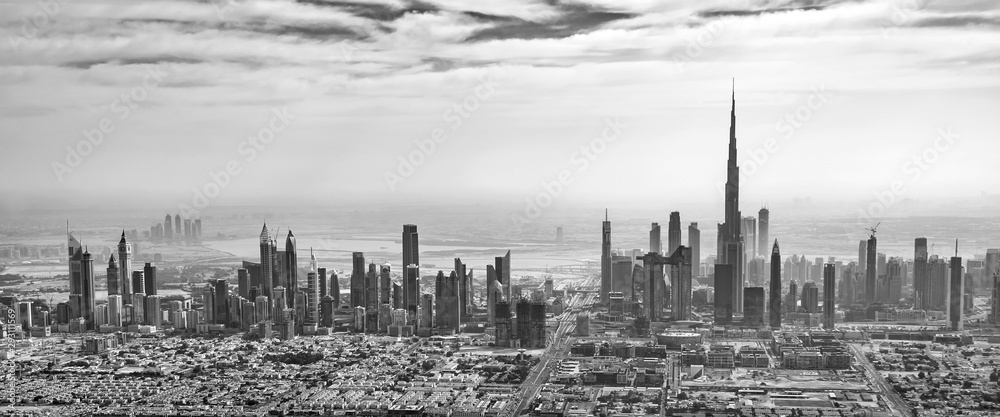 Fototapeta premium Panoramic aerial view of Dubai skyline in black and white, United Arab Emirates