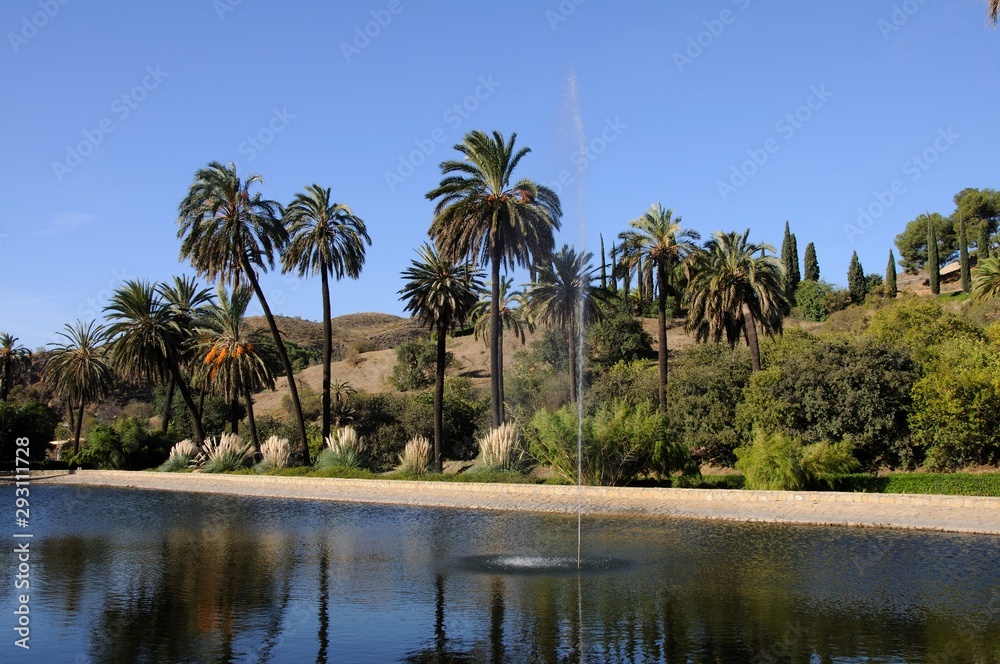 View of the lake with trees to the rear at La Concepcion historical botanical gardens, Malaga, Malaga Province, Andalucia, Spain, Europe