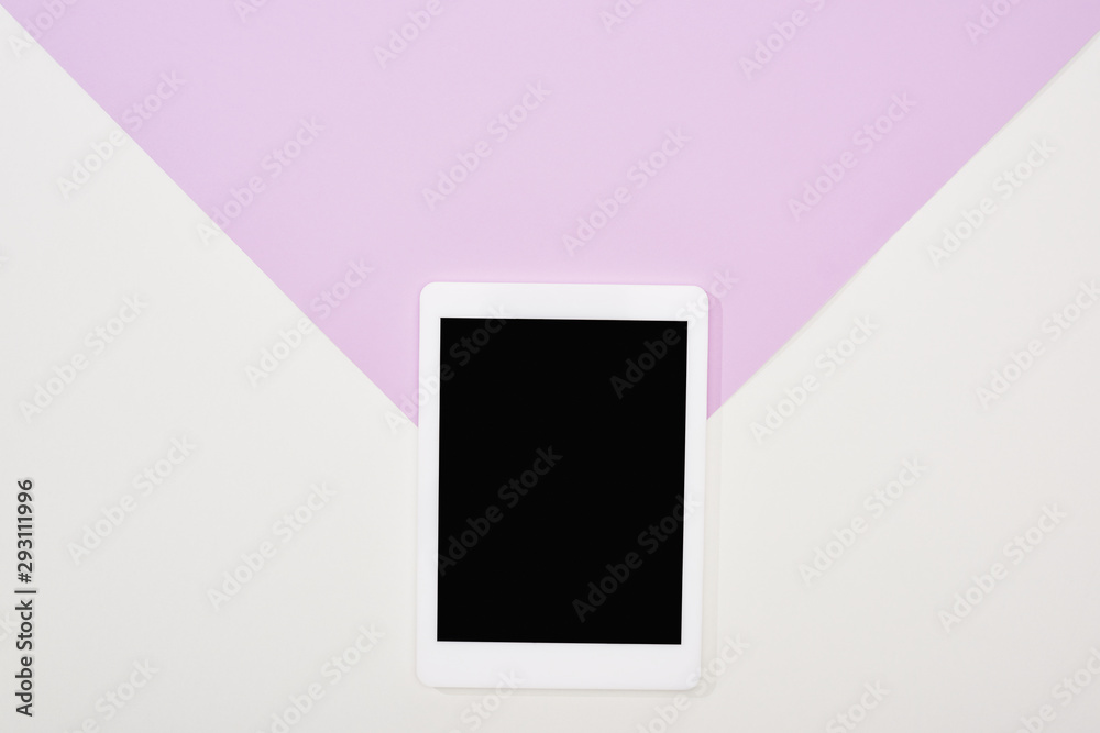 top view of digital tablet with blank screen on violet and white background