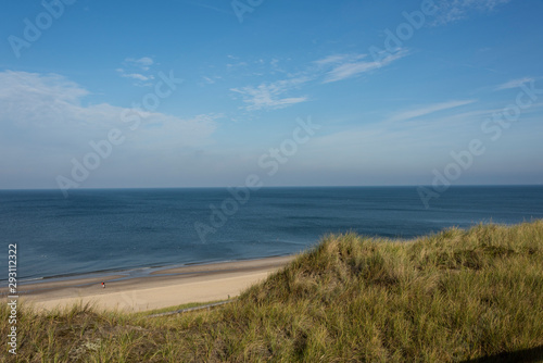 Beautiful tranquil dune landscape and long beach at North Sea