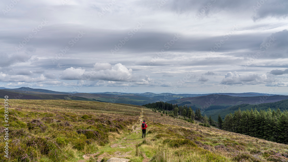 Wicklow way landscape, Glendalough vale, with a girl in the path.
