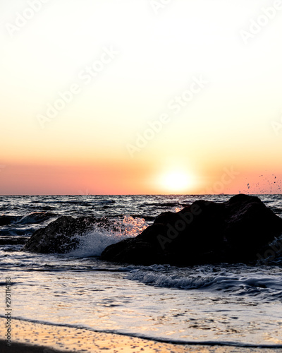 Beautiful sunset (sunrise) over the sea, beautiful waves.