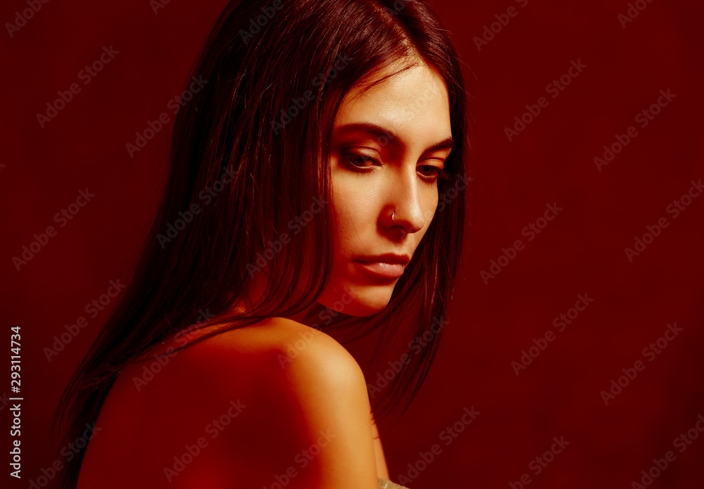 Fototapeta premium Close-up portrait of young woman with golden-red makeup.