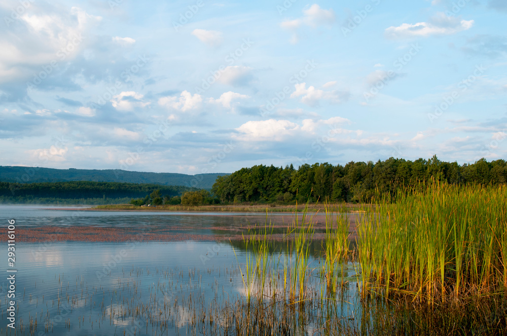 beautiful autumn lake overlooking mountains and blue sky