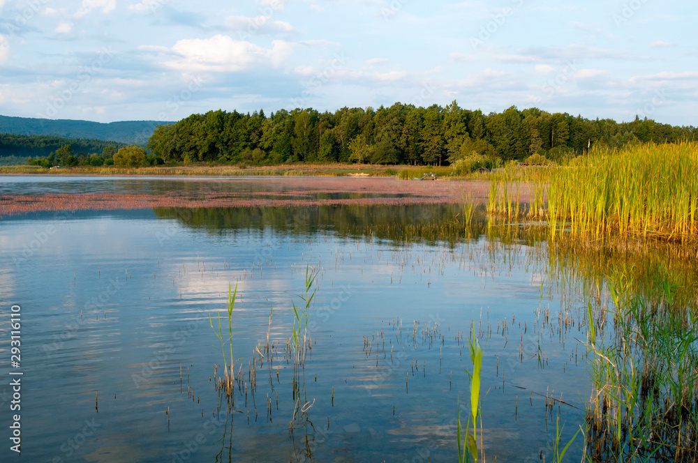 beautiful autumn lake overlooking mountains and blue sky