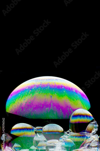 Rainbow colored spheres - beautiful  soap-bubble abstract on black background