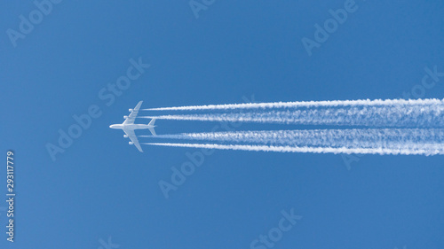 Fotografie four-engined jet aircraft, jet airbus a380 airplane in the sky with condensation