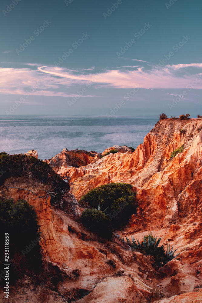 Ocean sand stone rock formation in the ocean  with morning sunrise light. Praia da Marinha, Famous Beach, Algarve Coast in South Portugal, Atlantic Ocean