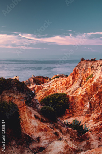 Ocean sand stone rock formation in the ocean with morning sunrise light. Praia da Marinha, Famous Beach, Algarve Coast in South Portugal, Atlantic Ocean