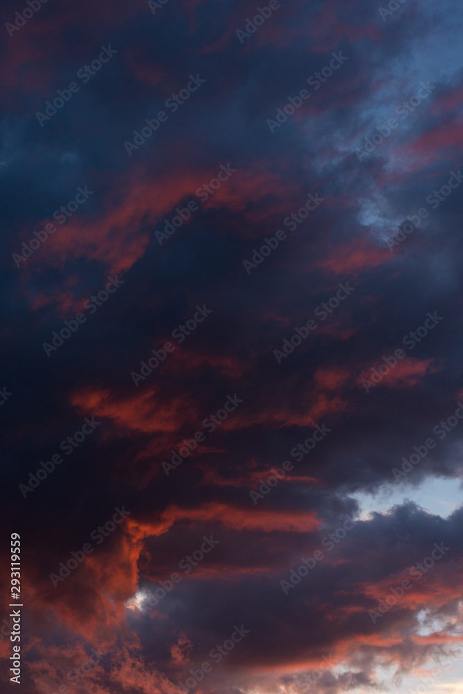 Fototapeta premium Storm clouds at sunset in bright colors