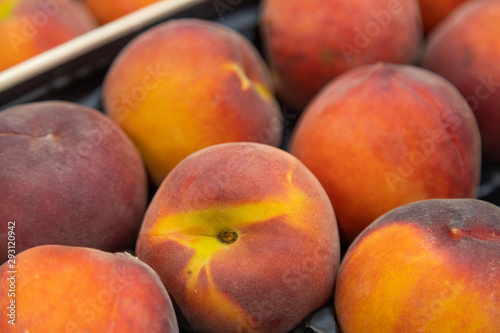 Fragrant ripe nectarine on market tray or box. For food illustration  agriculture purpose