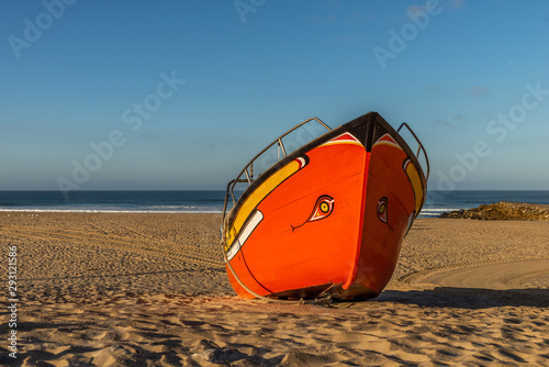 Traditional old Fishing boat bow on sand and blue sky as background