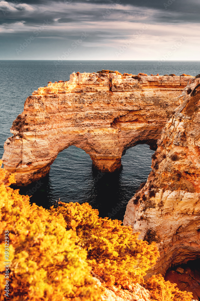 Famous view of one of the must see location at colorful sunset light and ocean view with the nature and sand stone coastline. Praia da Marinha, Famous Beach, Algarve Coast, Lagoa, Portugal