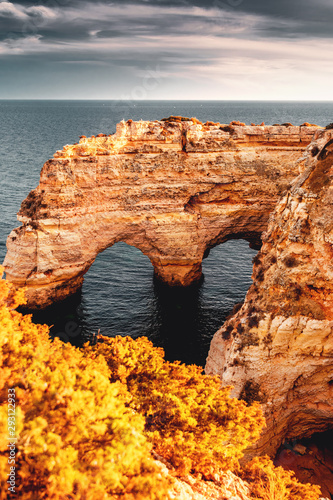 Famous view of one of the must see location at colorful sunset light and ocean view with the nature and sand stone coastline. Praia da Marinha  Famous Beach  Algarve Coast  Lagoa  Portugal