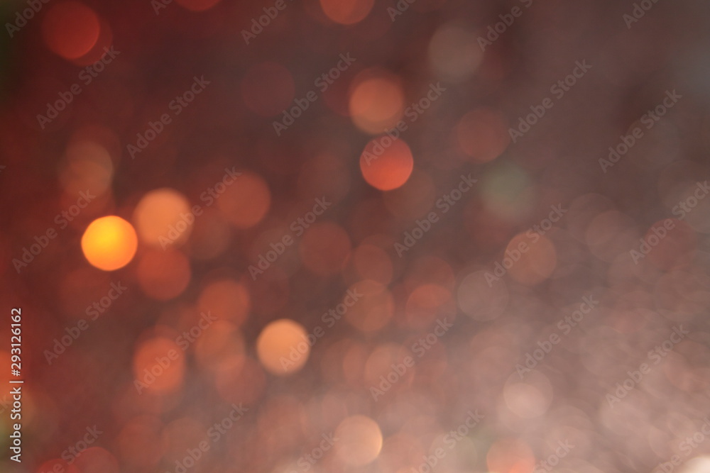 Defocused image with blinking shine. Brilliant circles on a lilac texture. Abstract blurred photo of light and bokeh. Festive trendy background. 
