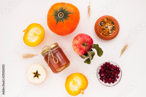 Fototapeta Naklejka Na Ścianę i Meble -  Fresh sliced pumpkin(squash), apples, glass jar of honey isolated on white background. Food, Thanksgiving day concept. Top view. Space for a text. Flat lay. Close up.