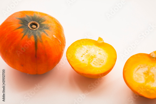 Fresh sliced pumpkin(squash), apples, glass jar of honey isolated on white background. Food, Thanksgiving day concept. Top view. Space for a text. Flat lay. Close up.