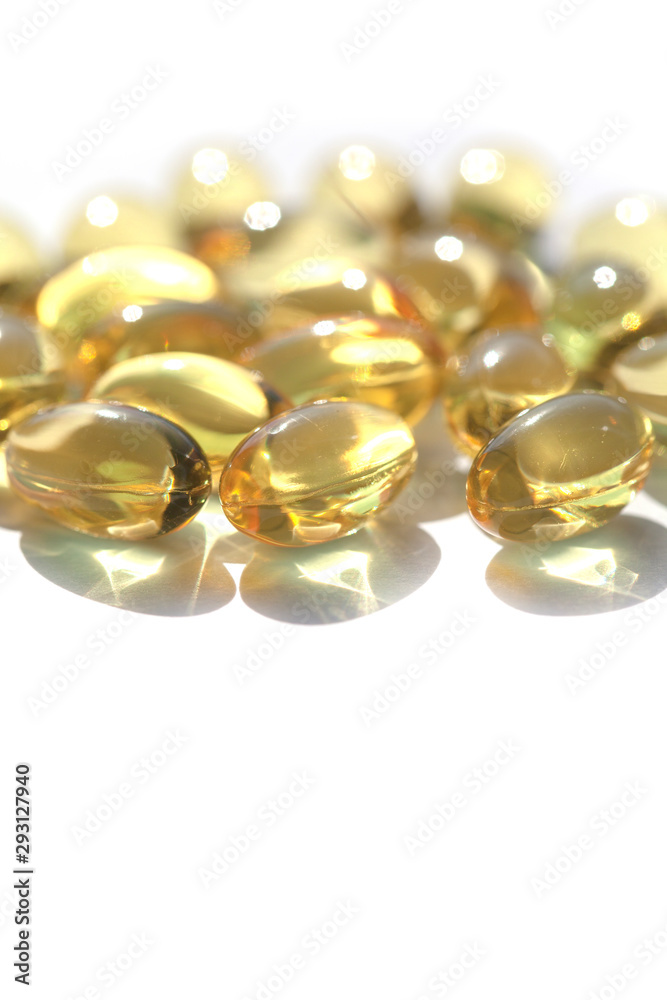 Capsules with fish oil, vitamins A and D. Vertical image Capsules with fish oil, vitamins A and D. Vertical image