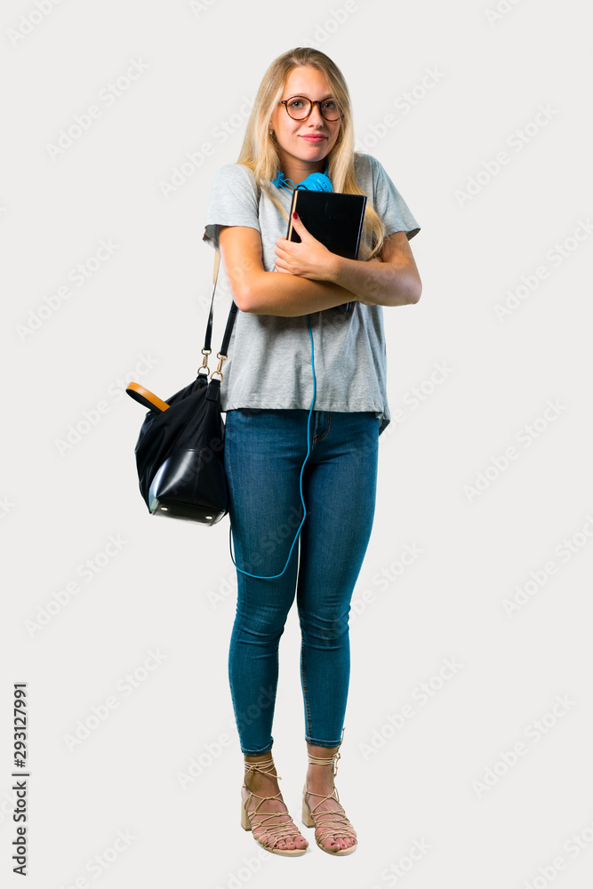 Full body of Student girl with glasses making unimportant and doubts gesture while lifting the shoulders on grey background Full body of Student girl with glasses making unimportant and doubts gesture while lifting the shoulders on grey background