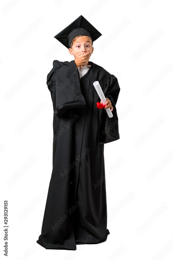 Full body of Little boy graduating covering mouth with hands on isolated white background Full body of Little boy graduating covering mouth with hands on isolated white background