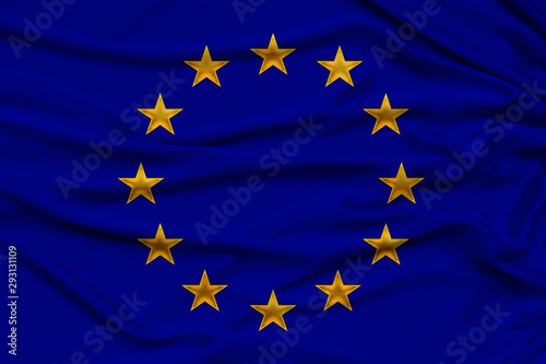 stylized European Union flag, symbol of united Europe on soft silk with soft folds, close-up