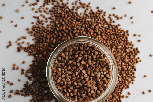 Wallpaper Mural Raw buckwheat in glass on white background, heathy food, diet Torontodigital.ca