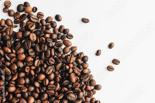 Close-up view of roasted coffee beans and glass cup