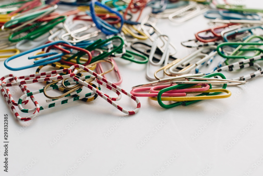 Pile of colorful paper clips on white background, flat lay Pile of colorful paper clips on white background, flat lay