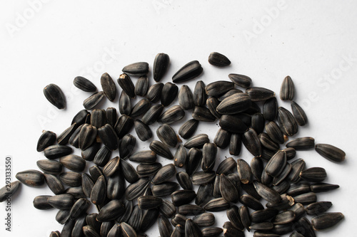 Pile of sunflower seeds on white background