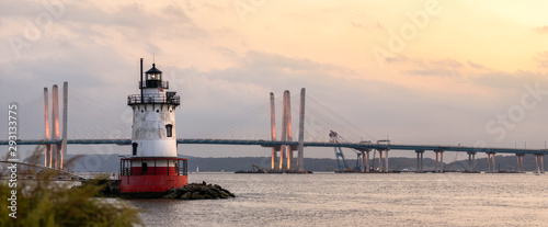 Panorama of a caisson (sparkplug) style lighthouse under soft golden light with a bridge in the background. Tarrytown Light on the Hudson River in New York.  photo