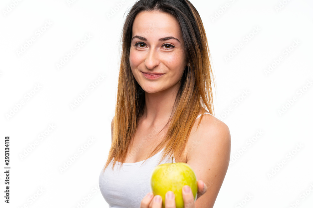 Young woman with an apple over isolated white background Young woman with an apple over isolated white background
