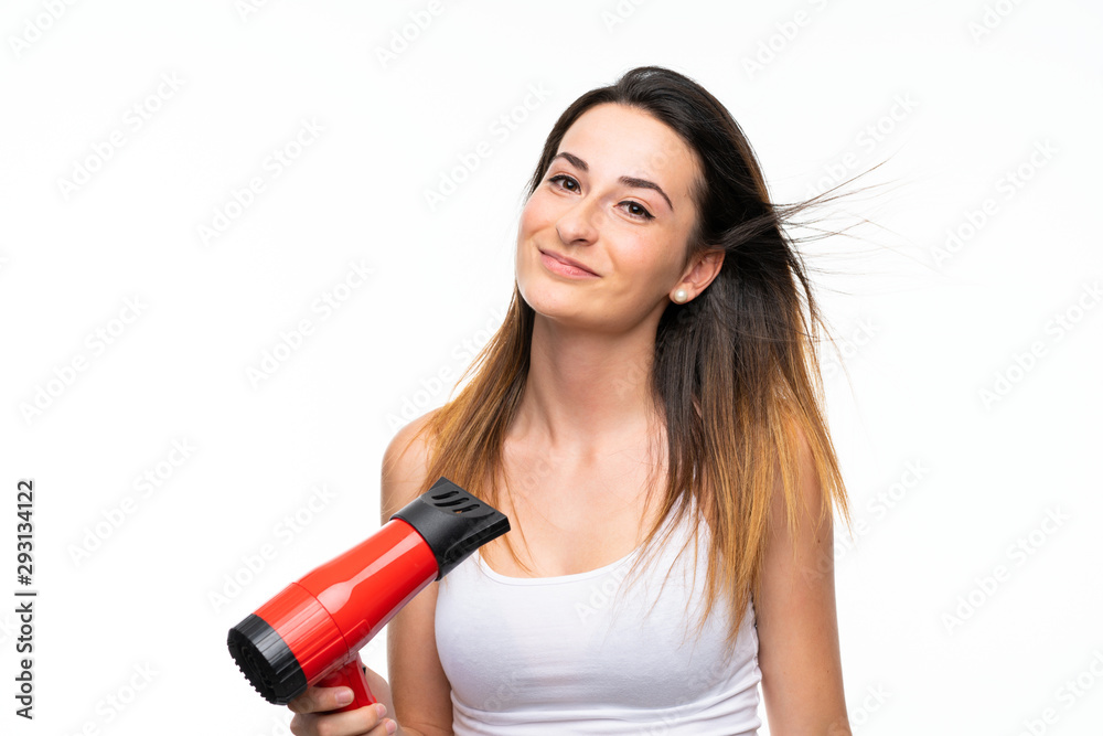 Young woman with hairdryer over isolated background Young woman with hairdryer over isolated background
