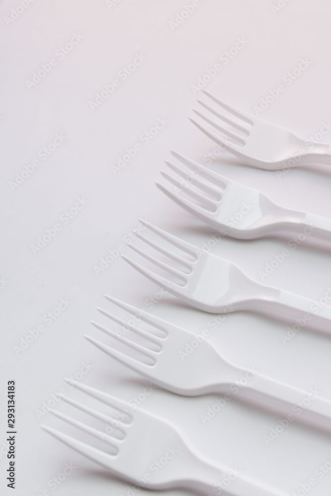 White plastic forks flat lay on white background White plastic forks flat lay on white background