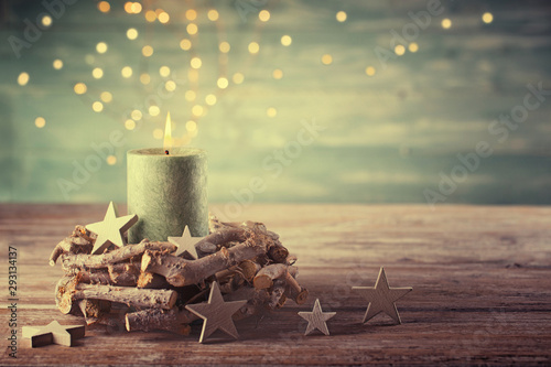First Advent Sunday - Christmas candle with magic lights  -  Natural advent decoration -  Wreath made of twigs  -  Rustic  simple background 