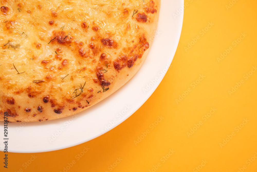 Fresh round cake on white plate on yellow background. Fresh round cake on white plate on yellow background.