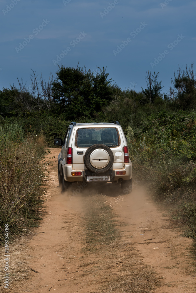 Cross Country Vehicle SUV On Dusty Gravel Road In Croatia Cross Country Vehicle SUV On Dusty Gravel Road In Croatia