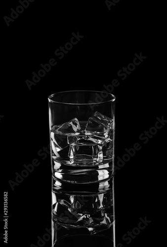 Vodka or gin tonic with ice in rocks glass on black background