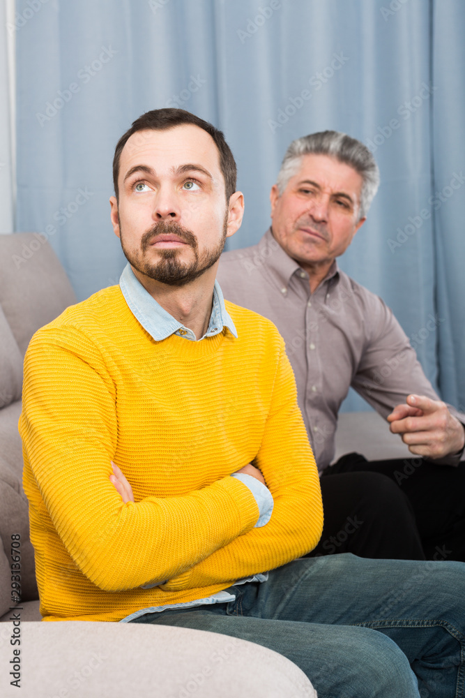 Fototapeta premium Adult father and son solve problems