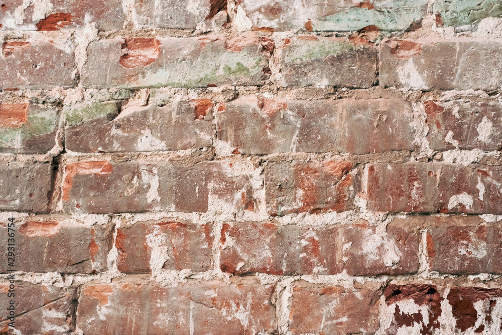 Old orange brick wall with cracks on the bricks. shabby vintage wall Old orange brick wall with cracks on the bricks. shabby vintage wall