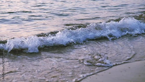 Wave of the sea or ocean in the calm on the sandy coast. Watching the waves