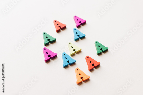 Colorful small scattered wooden A letters