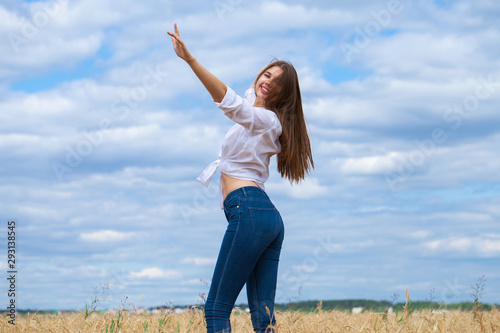 Young brunette woman in white shirt and blue jeans
