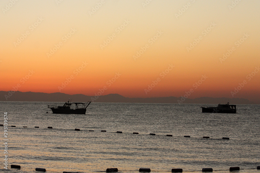Romanticly view of the sea, sunset, fishing boats, Turkey.