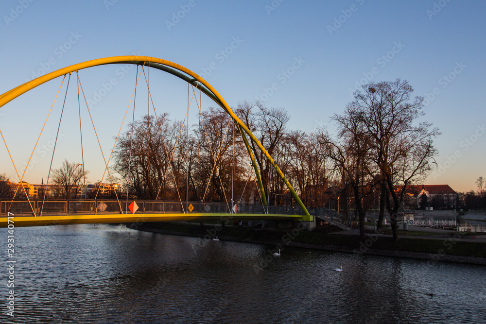 Pedestrian bridge over the river Odra in the Old Town of Wroclaw at sunset. Poland