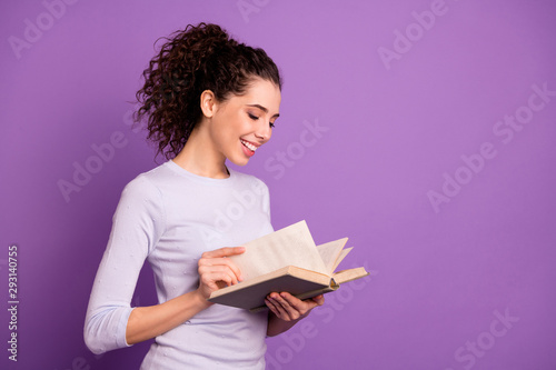 Photo of sweet cute girlfriend leafing through her book to learn new information holding hands isolated over purple pastel color background