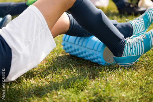 Young Athlete Boy Using Foam Roller on Sports Training. Soccer Player on Warm-up Cooldown After Outdoor Practice