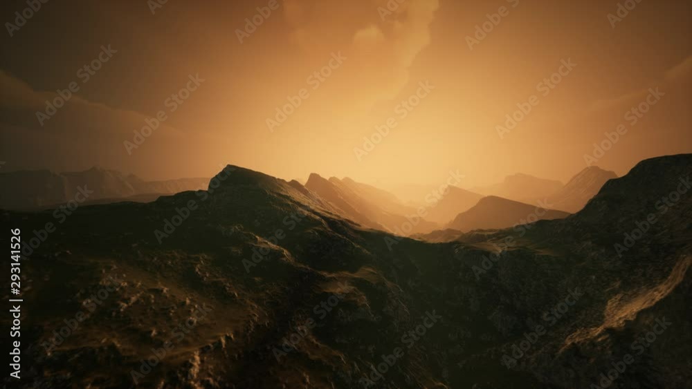 High mountain peaks covered with dramatic heavy fog. Misty mountains in a sunset light. High mountain peaks covered with dramatic heavy fog. Misty mountains in a sunset light.