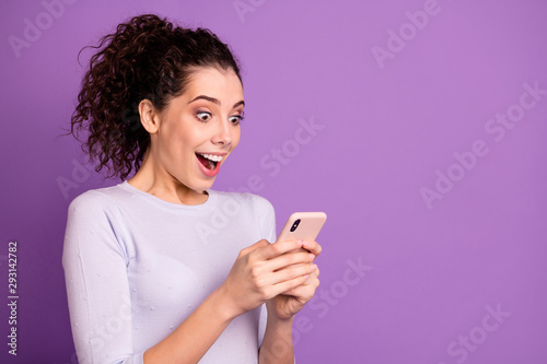 Close-up portrait of her she nice attractive lovely pretty cheerful glad amazed wavy-haired girl using device gadget 5p app web service isolated over violet lilac purple pastel color background